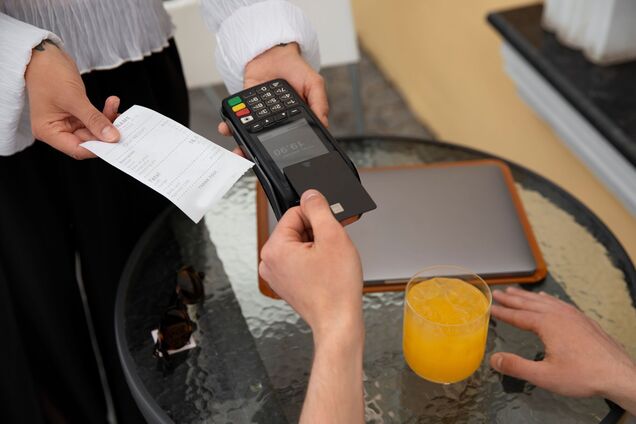 high-angle-customer-paying-with-nfc-device.jpg
