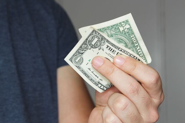 closeup-shot-person-holding-us-dollar-bill-his-hand.jpg